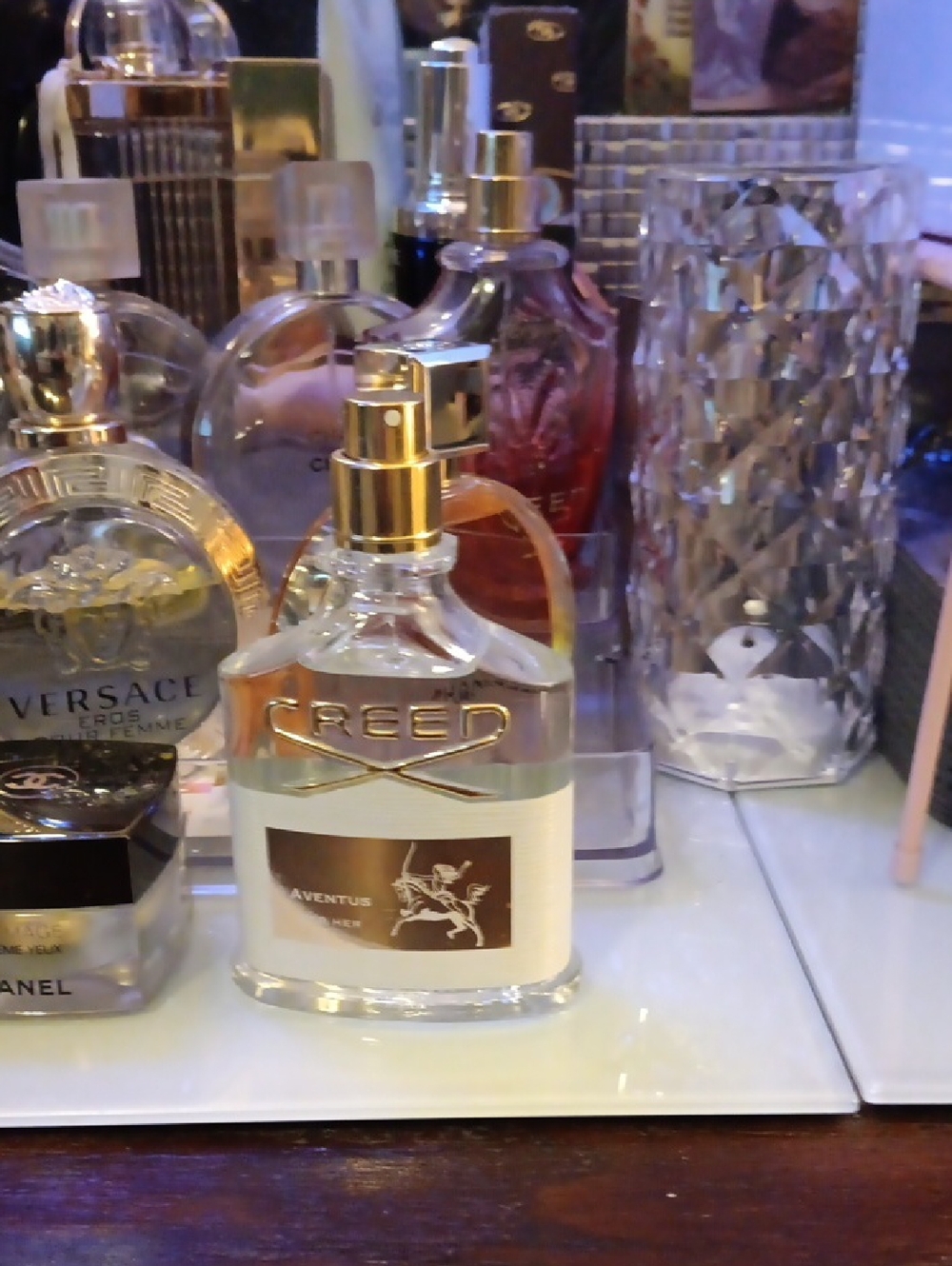 Creed Aventus Bottle with Clear Glass and Gold Accents.